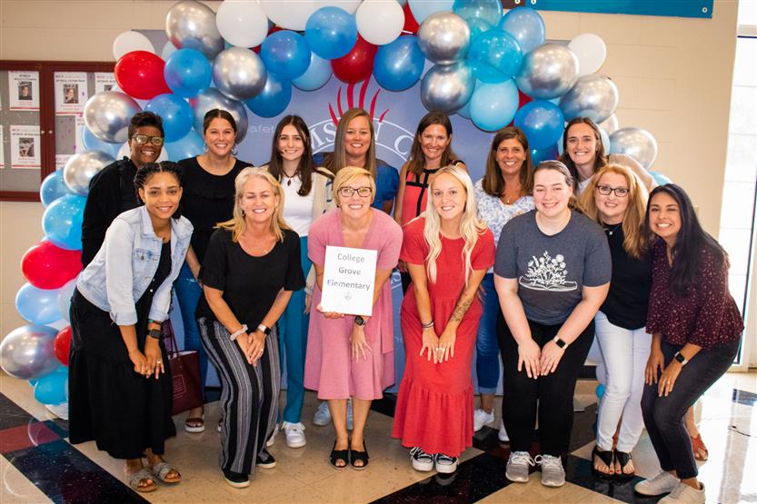 A group of teachers smile